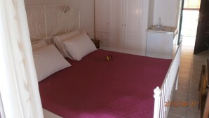A bedroom with a bed, white wardrobe, and a nightstand. - La Casa D' Irene (Lefkada)