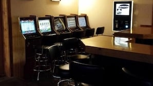 A conference room with a long table and several chairs, equipped with multiple computer monitors.