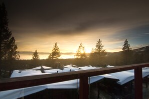 A view from a balcony with snow-covered tables and a lake in the background. - Tahoe Chaparral (Incline Village)