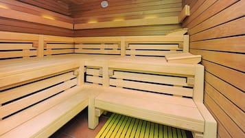 A sauna with wooden benches and a sloped ceiling.