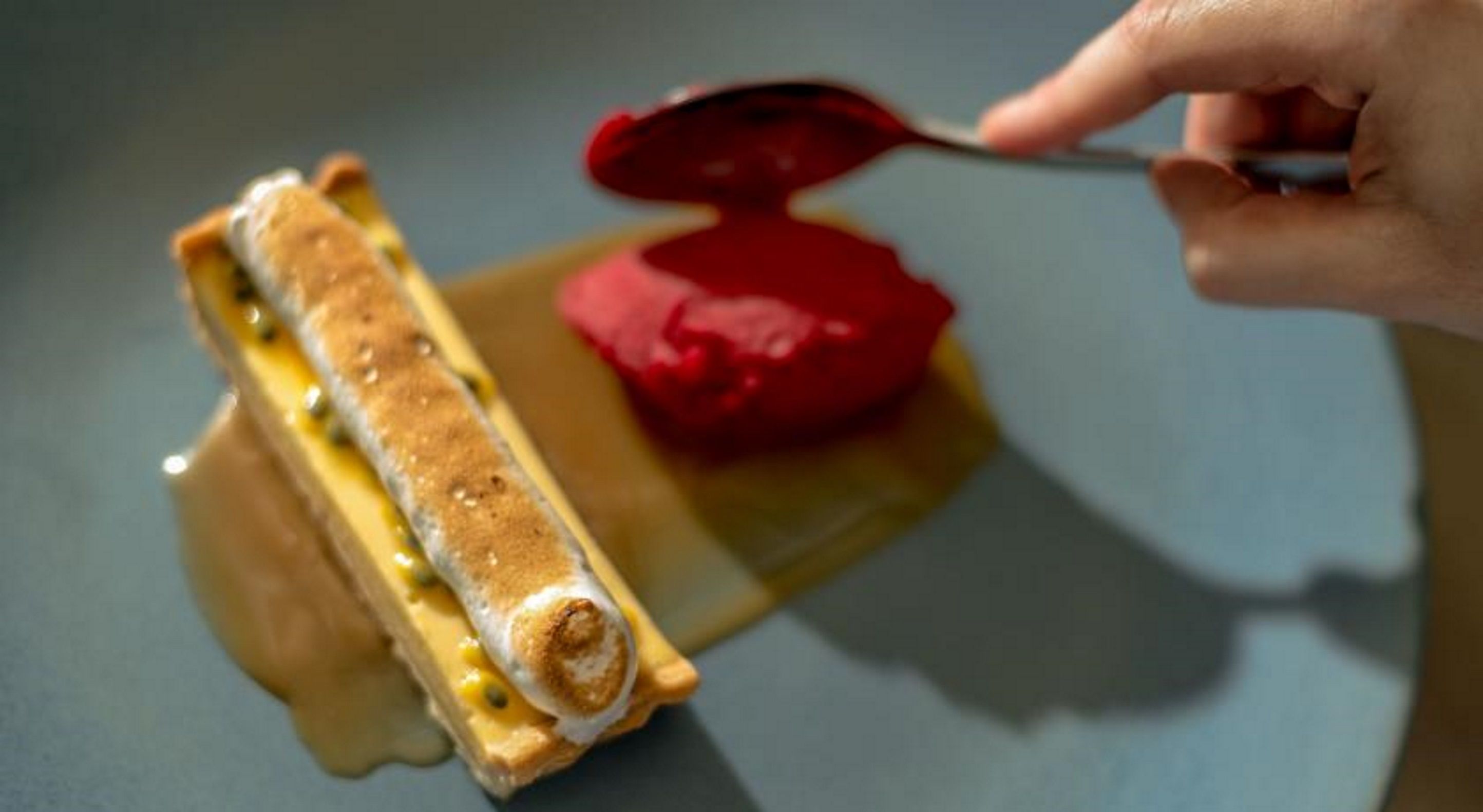 Un sándwich con una cucharada de salsa roja en un plato.