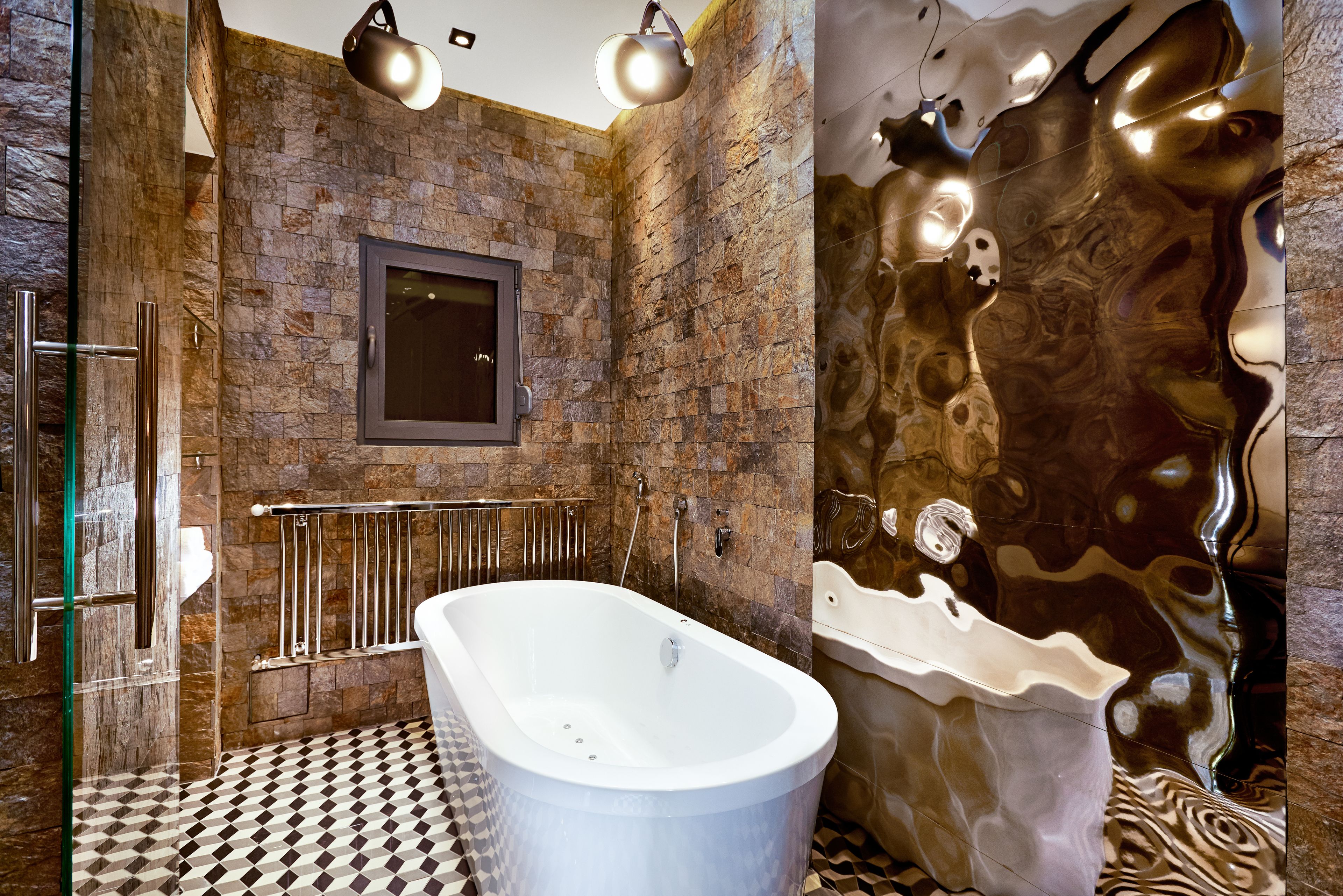 A bathroom with a freestanding bathtub, a glass shower enclosure, and a mirror on the wall.