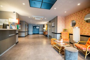 Relax in the hotel's central reception area, surrounded by comfortable seating and a stylish design.