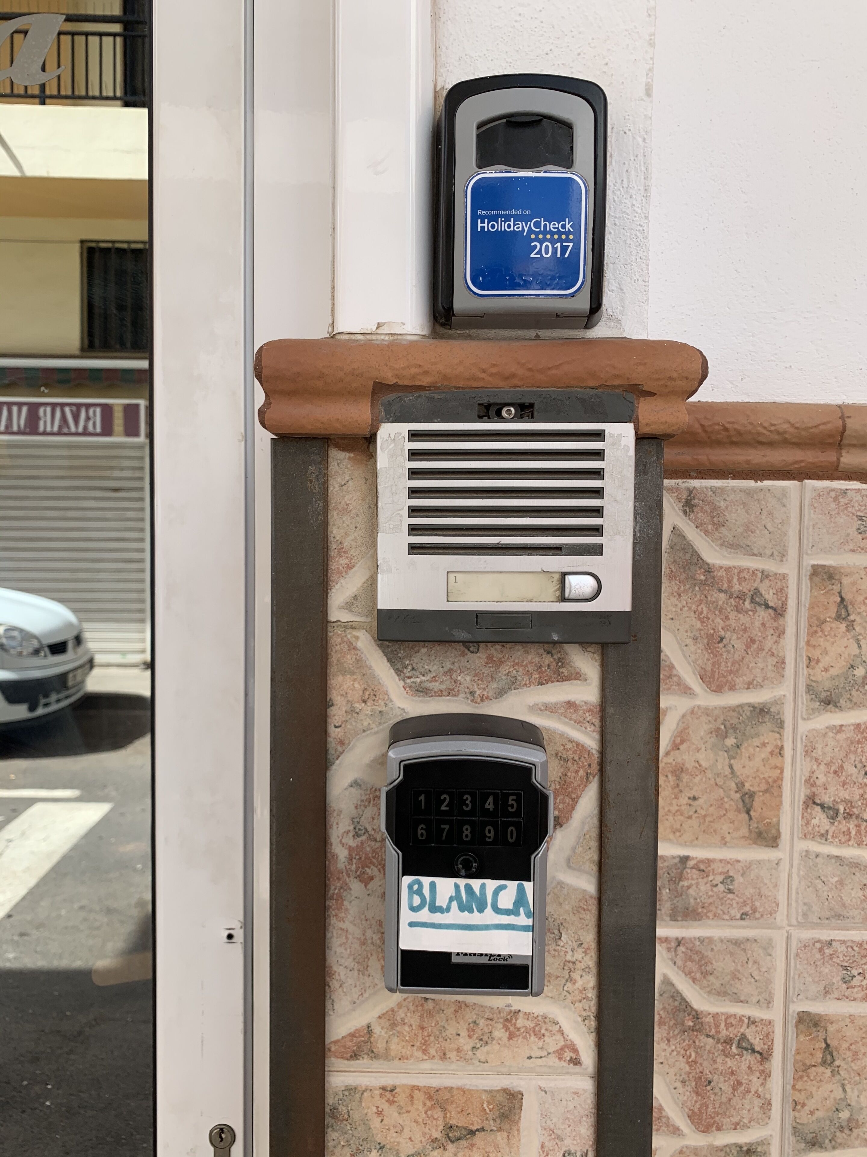 A security keypad with a lock and a keyhole on a wall.