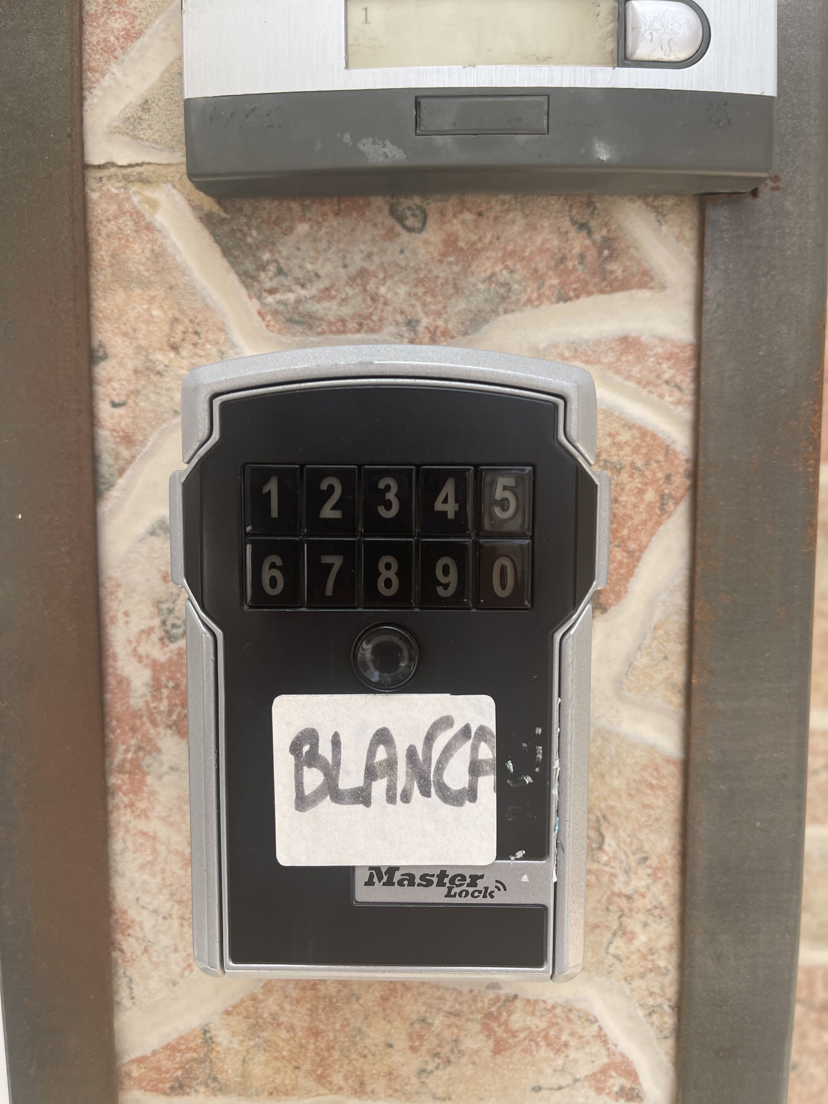 A keypad with a label reading "BLANCA" and the Master Lock logo.