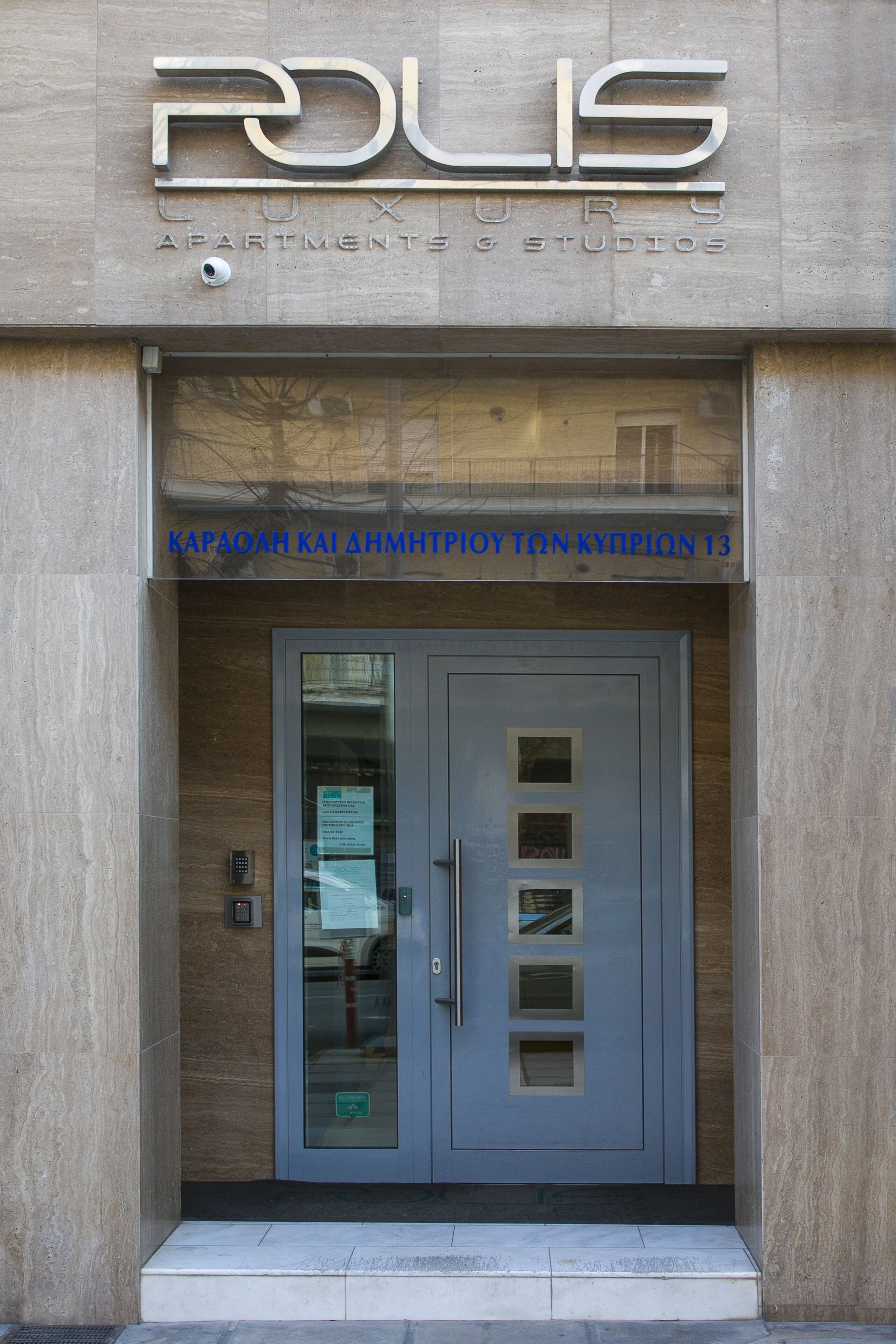 A building entrance with a modern design, featuring a prominent 'PODIS' sign above the door.