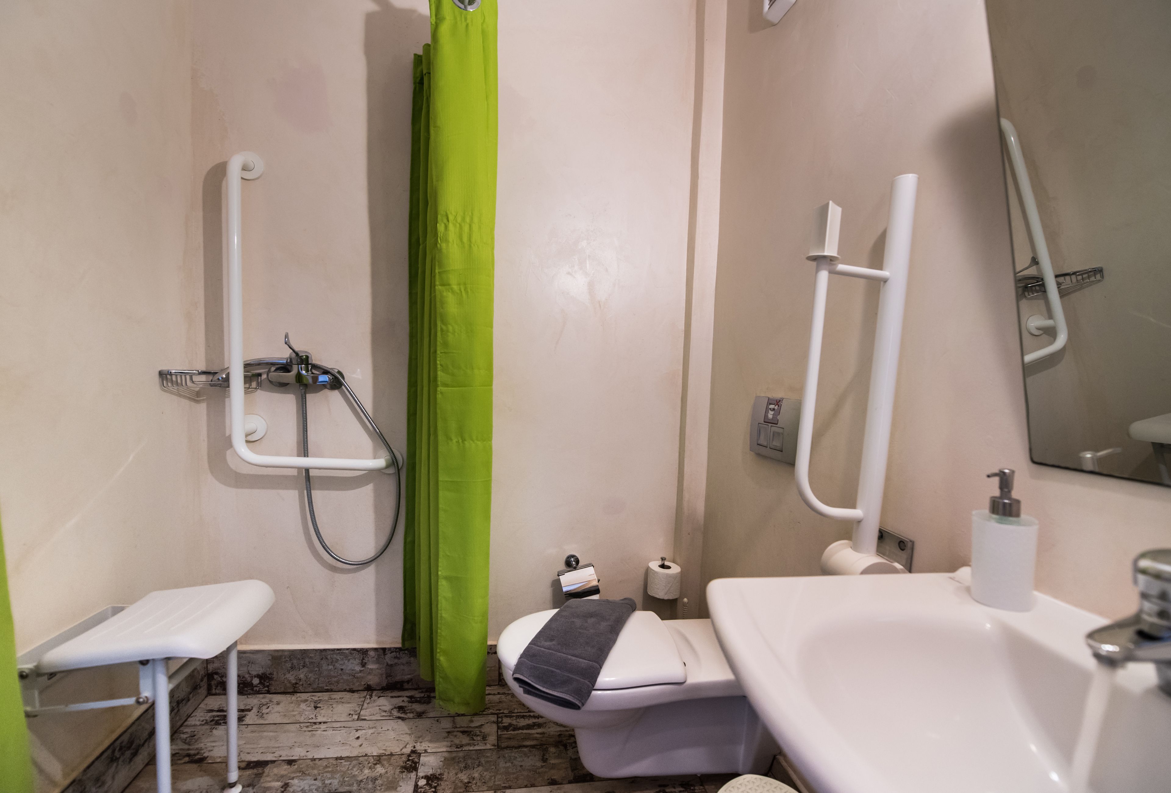 A bathroom with a shower, toilet, and sink.