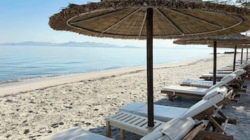 On the beach, sun-loungers, beach umbrellas