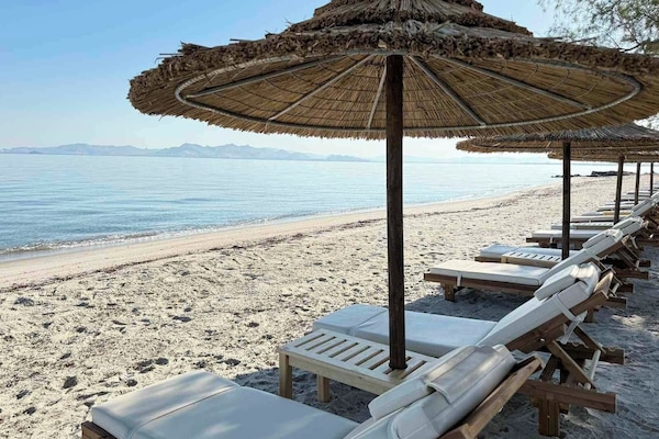 On the beach, sun loungers, beach umbrellas