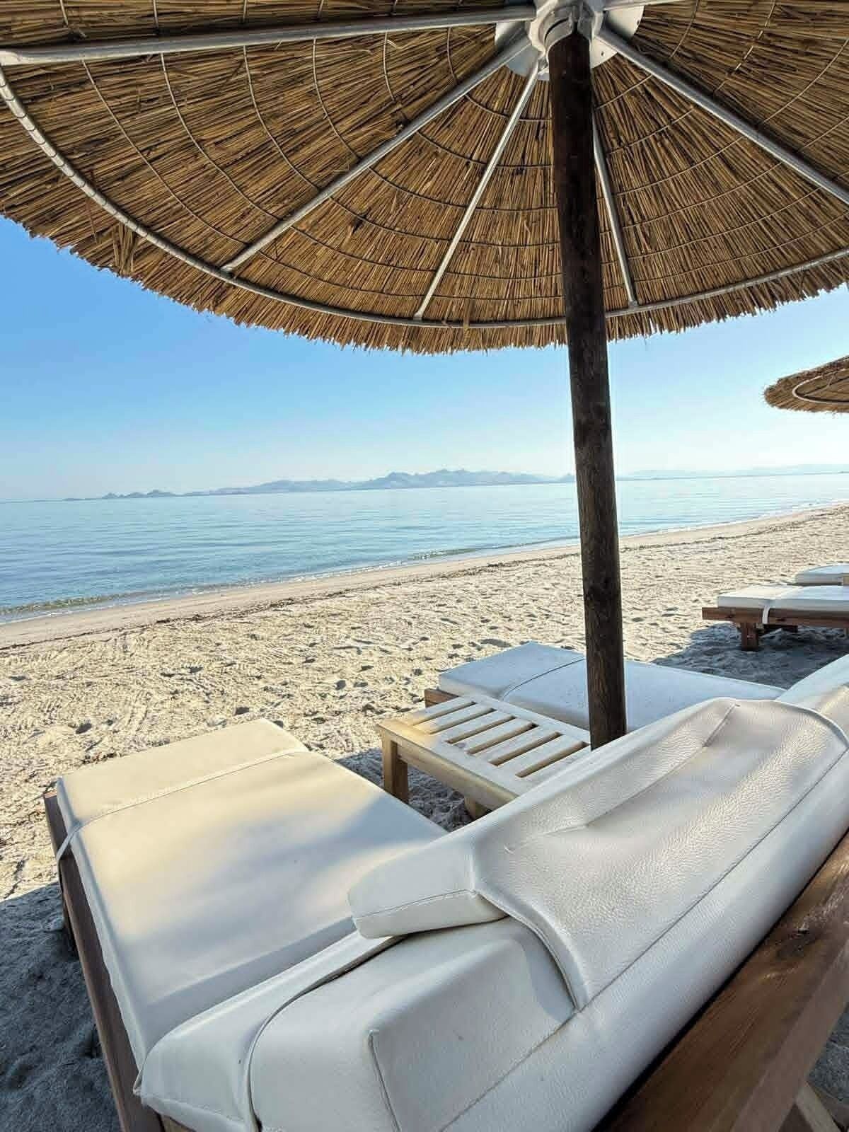 On the beach, sun loungers, beach umbrellas