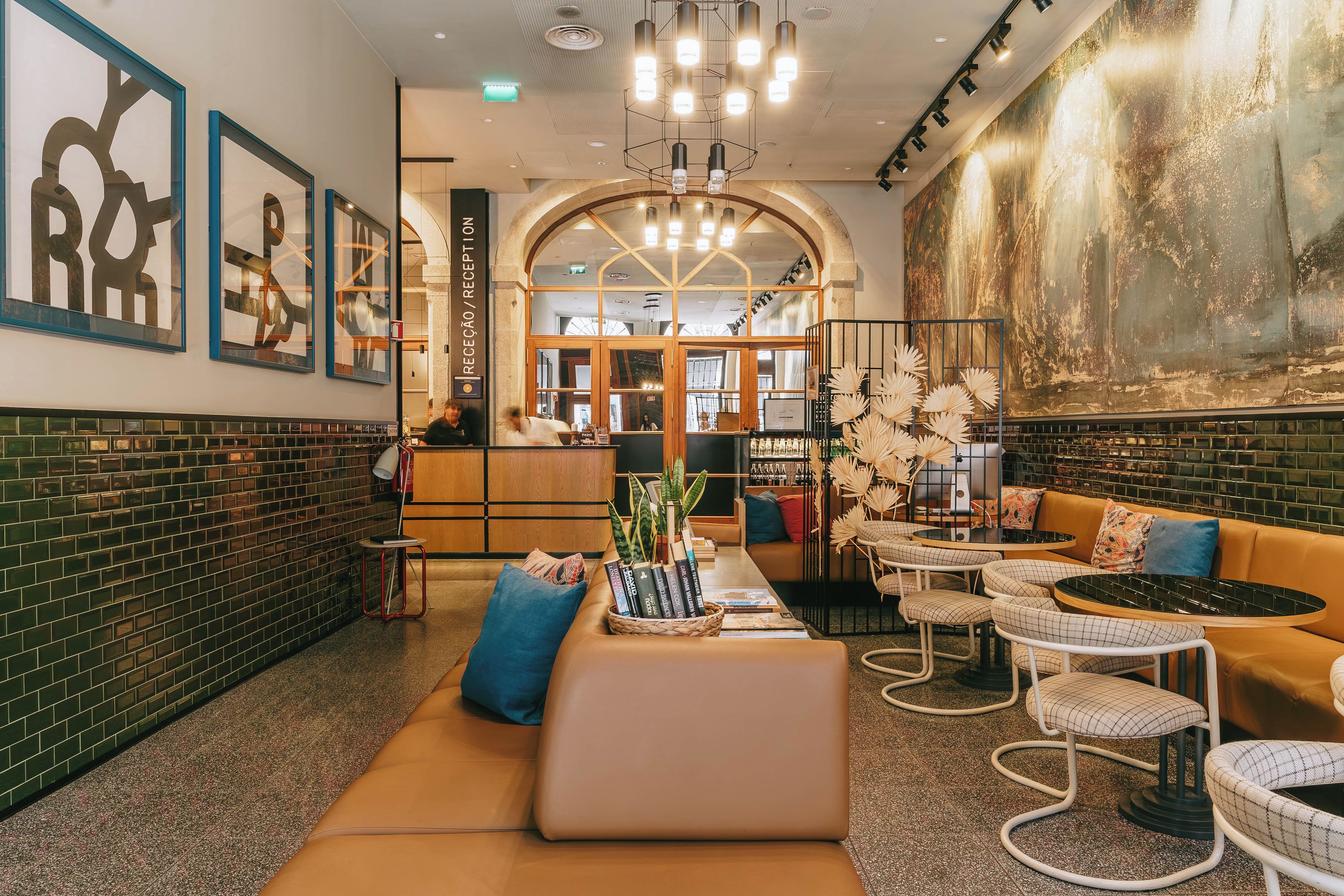 A modern interior with a reception desk, seating area, and a large abstract painting on the wall.
