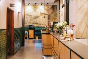 A hotel lobby with a bar area, a reception desk, and a large wall mural. - The Editory House Ribeira Porto Hotel (Porto)