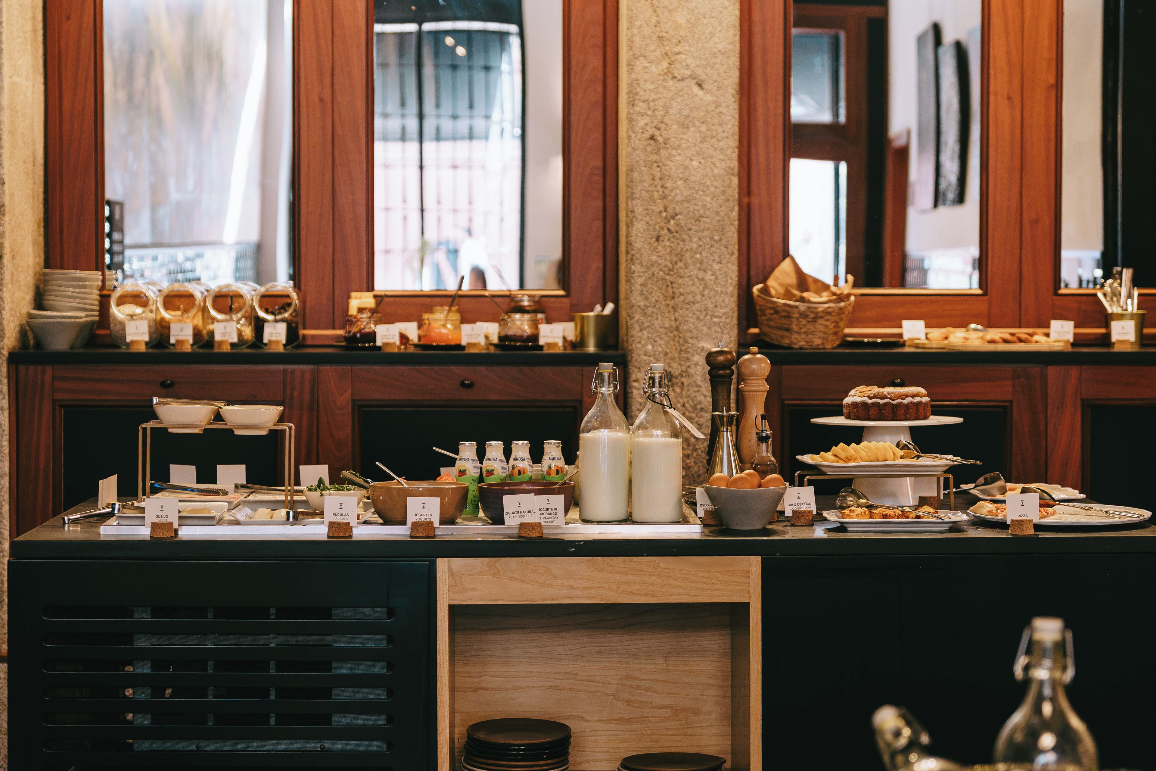 A buffet setup with various food items and condiments.