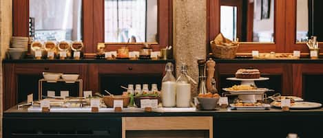 A buffet setup with various food items and condiments.