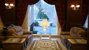 A luxurious living room with two leather sofas, a large ornate rug, and a decorative lamp. - Latanya Palm & Spa Airport Antalya (Antalya)