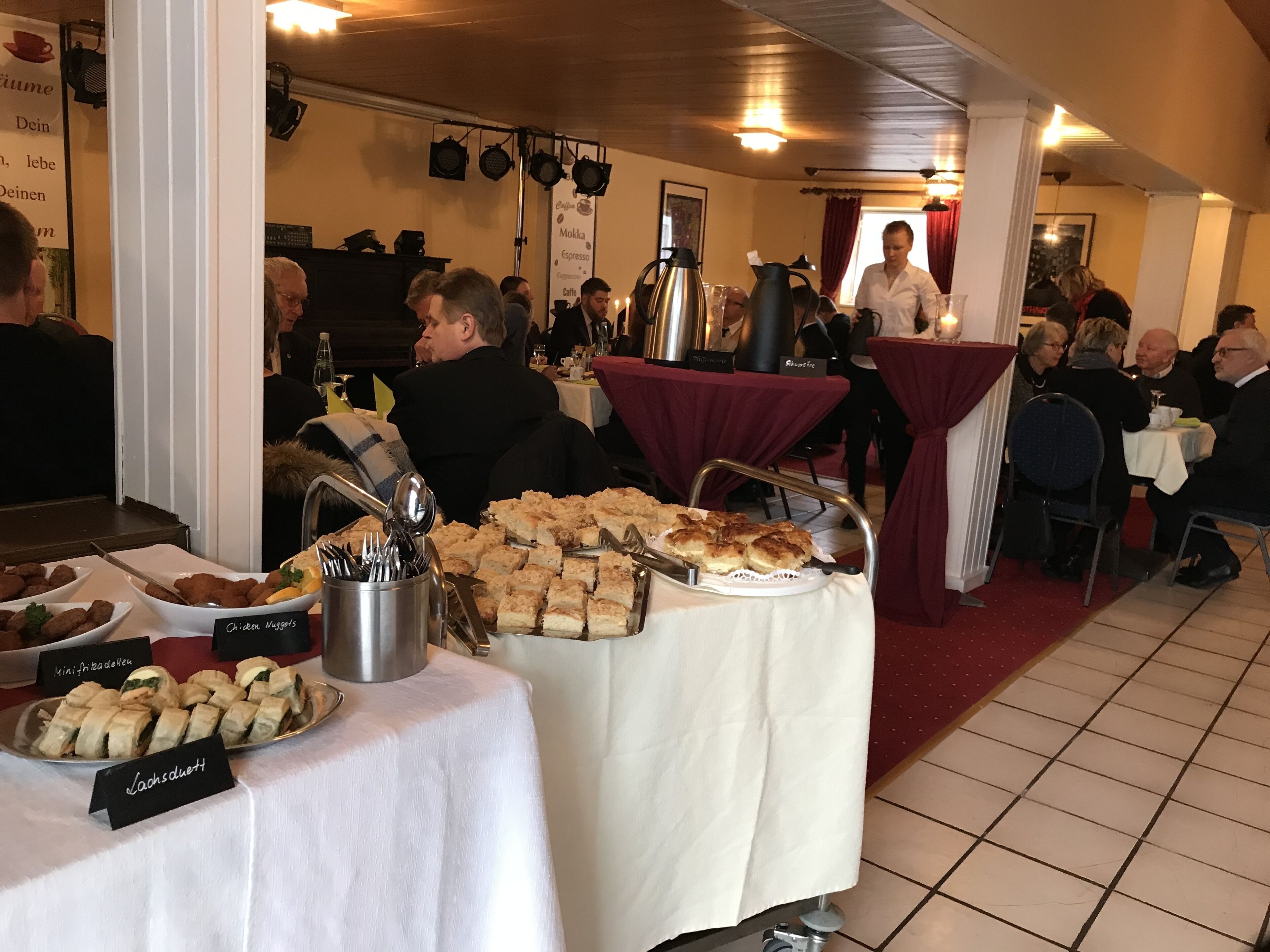 Montaje tipo bufé con diferentes opciones de comida y una estación de café.