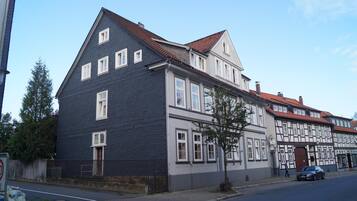 A two-story building with a dark facade and a red-tiled roof.