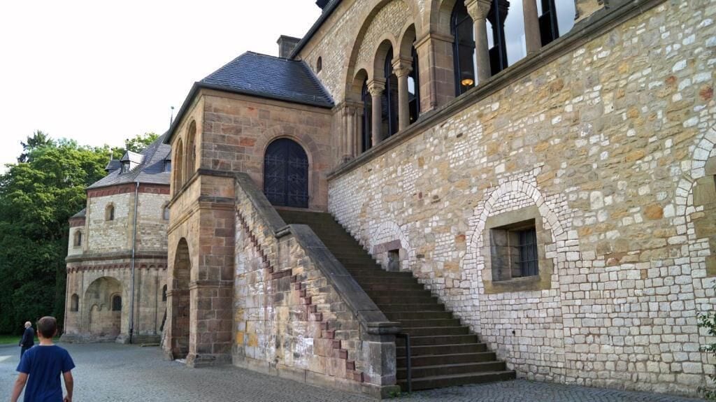 A historic stone building with a staircase leading to an entrance.