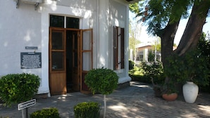 A reception area with a wooden door, a signboard, and a disclaimer notice.