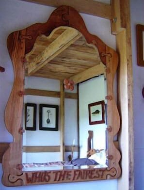 A wooden-framed mirror with the inscription "WHOS THE FAIRIEST" on a wall. - Sycamore Avenue Treehouses (Mooirivier)