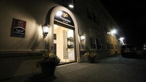A hotel entrance with a sign for 'Premiere Suites' and 'Signal Hill Gate'.