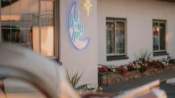 A building with a neon sign that reads "Good Night" and a star symbol.