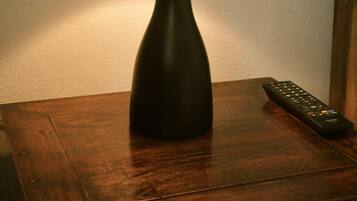 A table lamp with a textured lampshade on a wooden table.
