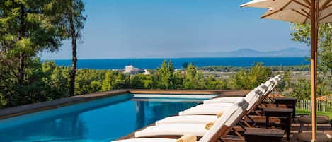 Outdoor pool, a heated pool, pool umbrellas, pool loungers
