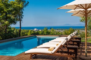 Outdoor pool, a heated pool, pool umbrellas, pool loungers