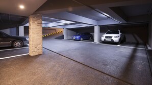 A parking garage with multiple levels and a brick pillar. - Hotel Gray (Changwon)