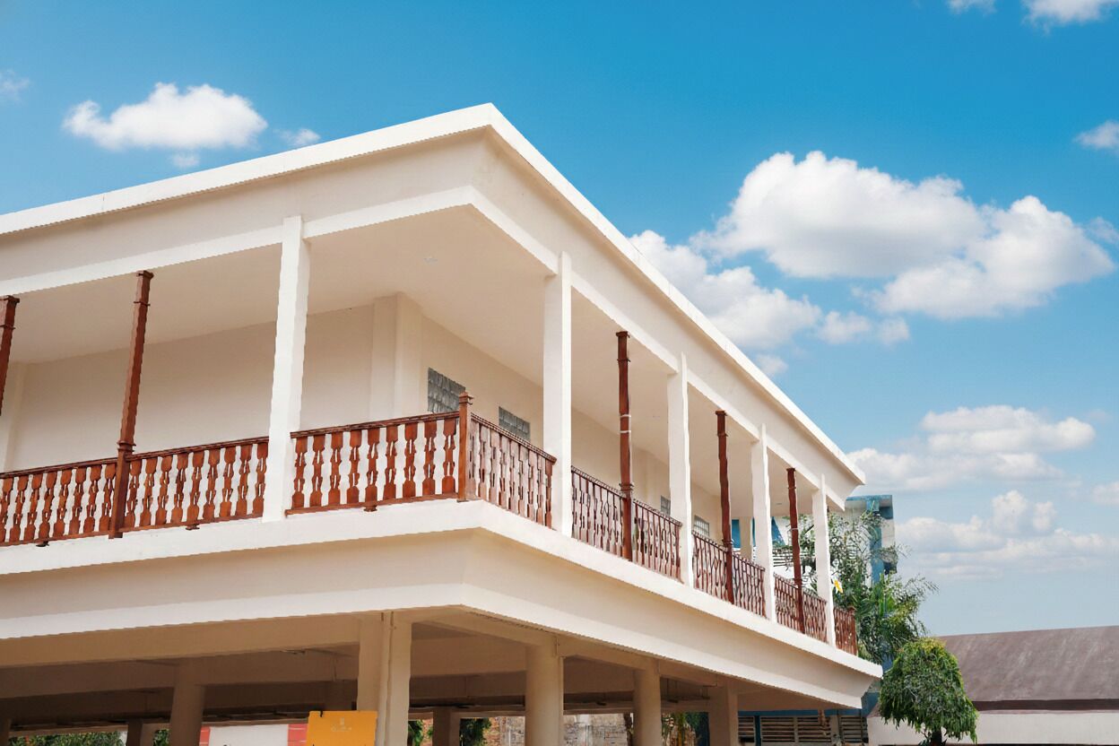A multi-story building with a balcony on the second floor.