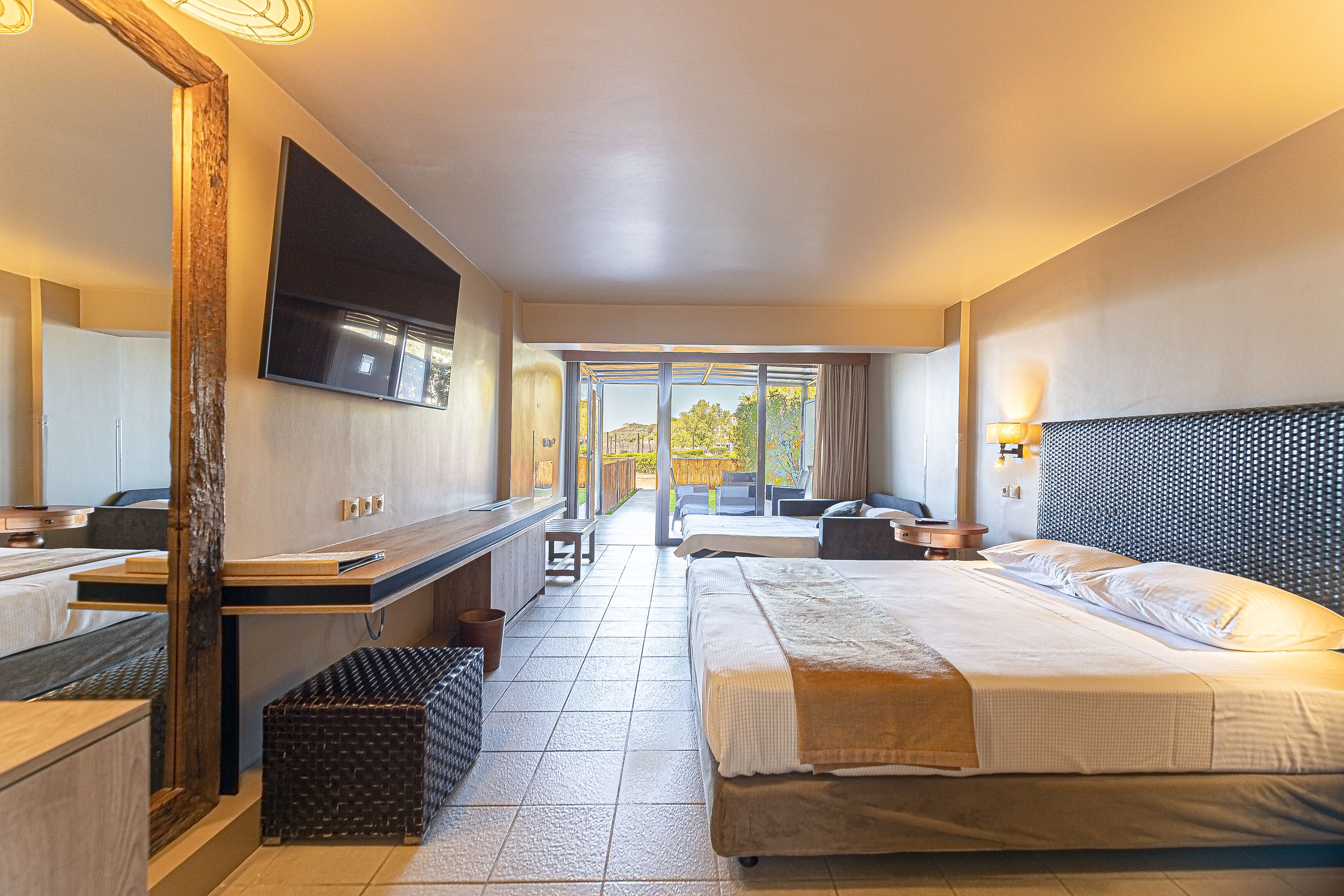 triple room, garden view | minibar, in-room safe, desk, laptop workspace