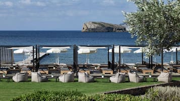 On the beach, white sand, sun loungers, beach umbrellas