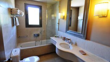 A modern bathroom with a bathtub, toilet, and sink.