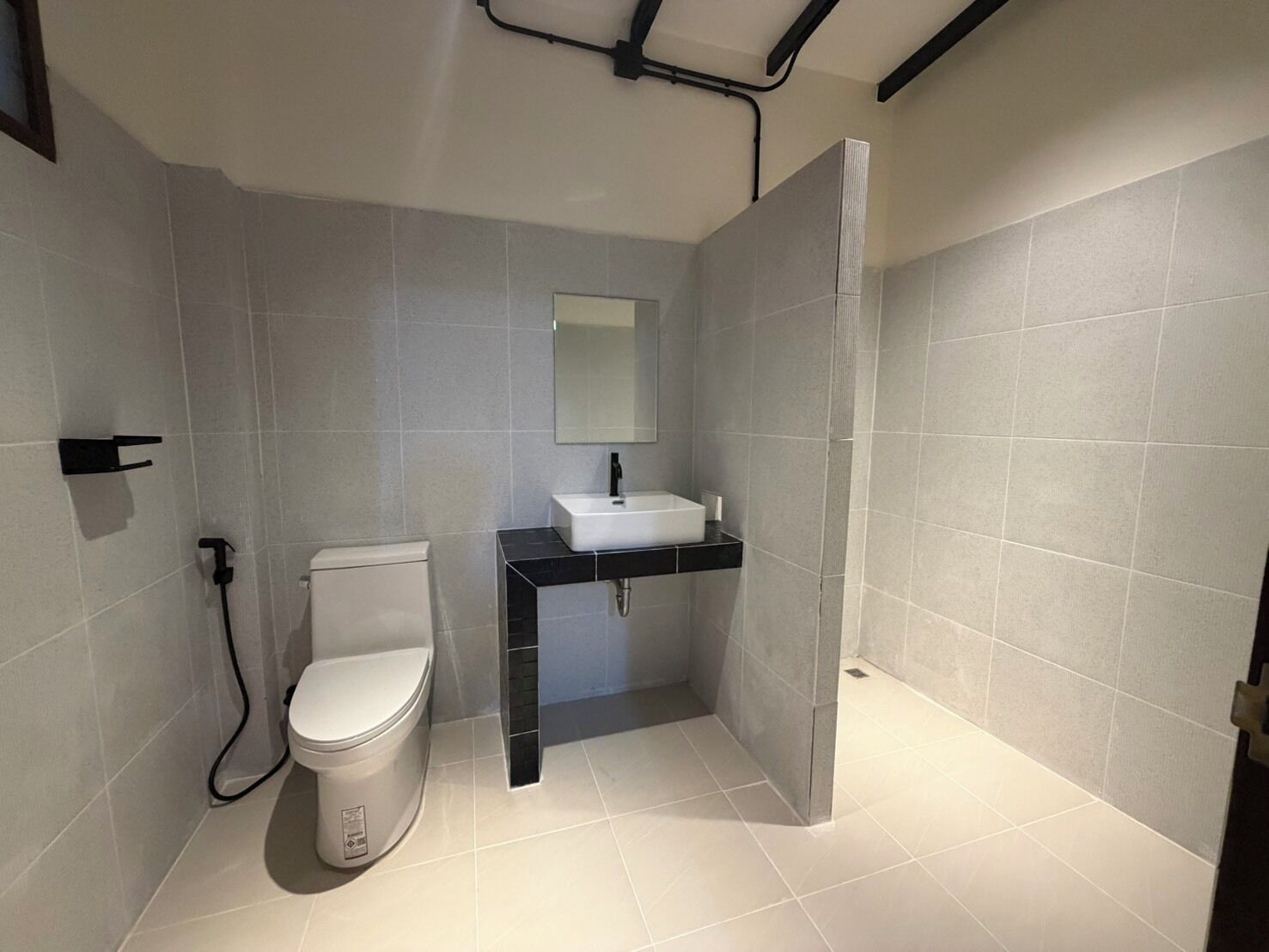 Un baño pequeño con inodoro, lavamanos y espejo.