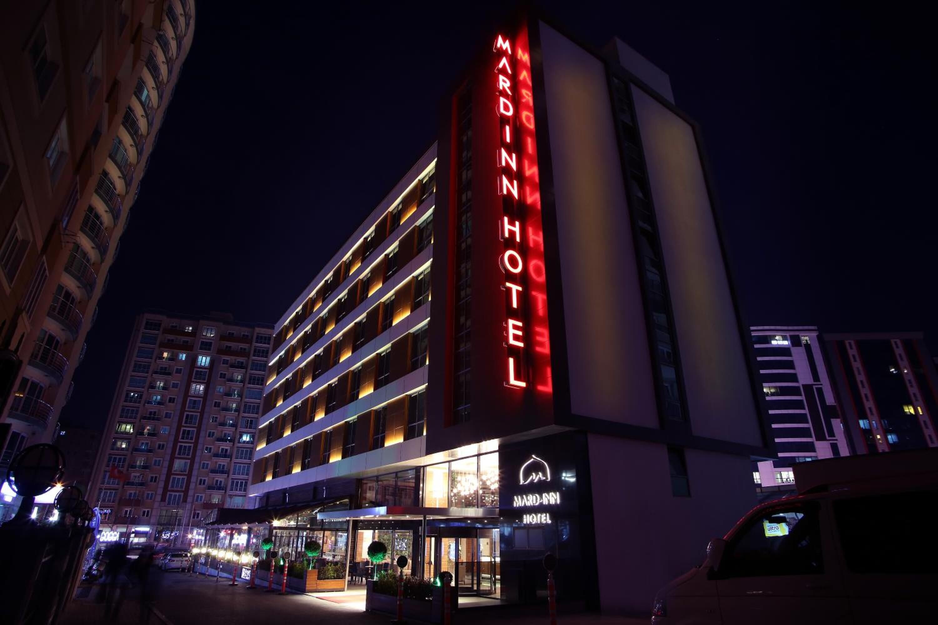 A multi-story hotel with a prominent red sign reading "MARDIN HOTEL".