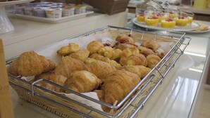 A breakfast buffet with pastries and beverages.