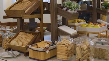 A buffet with various food items including bread, biscuits, and fruits.