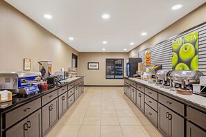 A self-serve breakfast area with multiple coffee machines, a food display, and a window with blinds. - La Quinta Inn & Suites by Wyndham Gillette (Gillette)