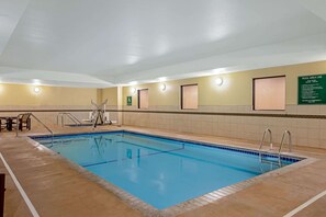 An indoor swimming pool with clear lane markings, a lifeguard chair, and a sign indicating pool area use. - La Quinta Inn & Suites by Wyndham Gillette (Gillette)