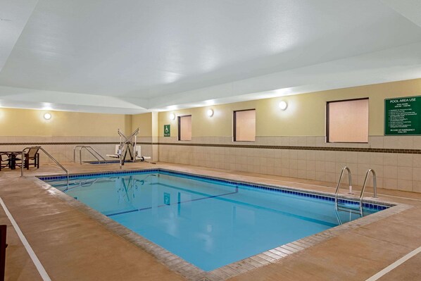 An indoor swimming pool with clear lane markings, a lifeguard chair, and a sign indicating pool area use. - La Quinta Inn & Suites by Wyndham Gillette (Gillette)