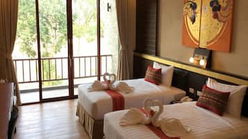 A hotel room with two beds, a balcony, a painting on the wall, and a desk.