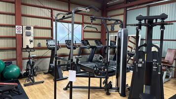A gym with exercise equipment, treadmills, and weight machines.