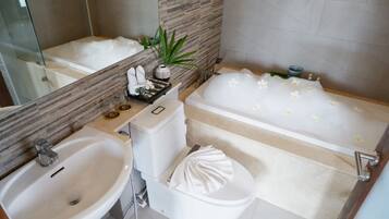 A bathroom with a bathtub, a sink, and a toilet.