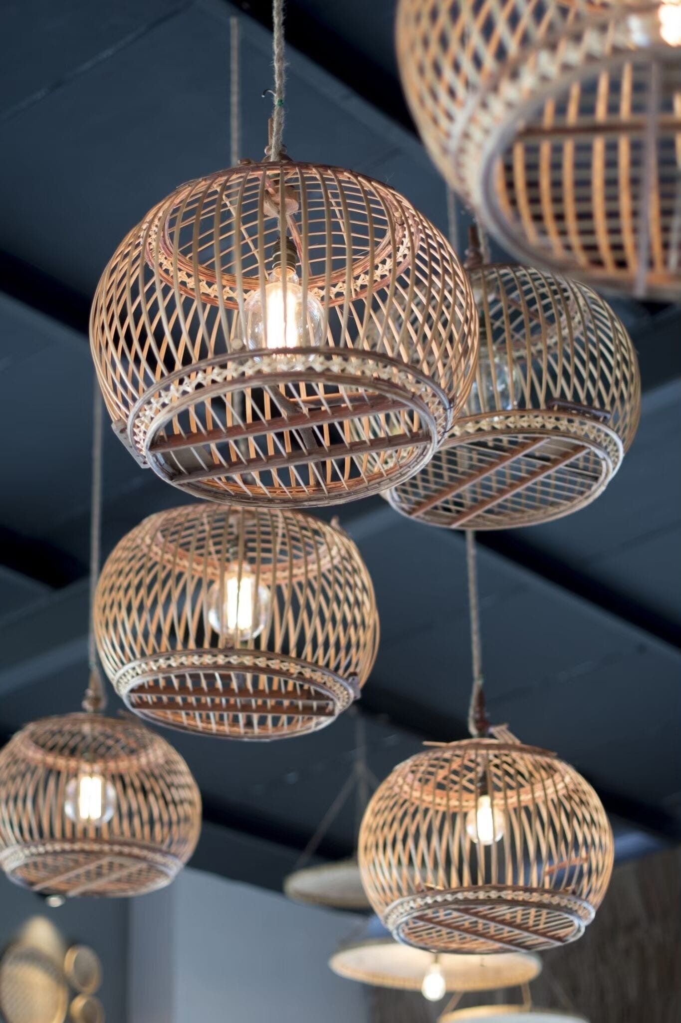 A series of spherical, woven light fixtures suspended from the ceiling.