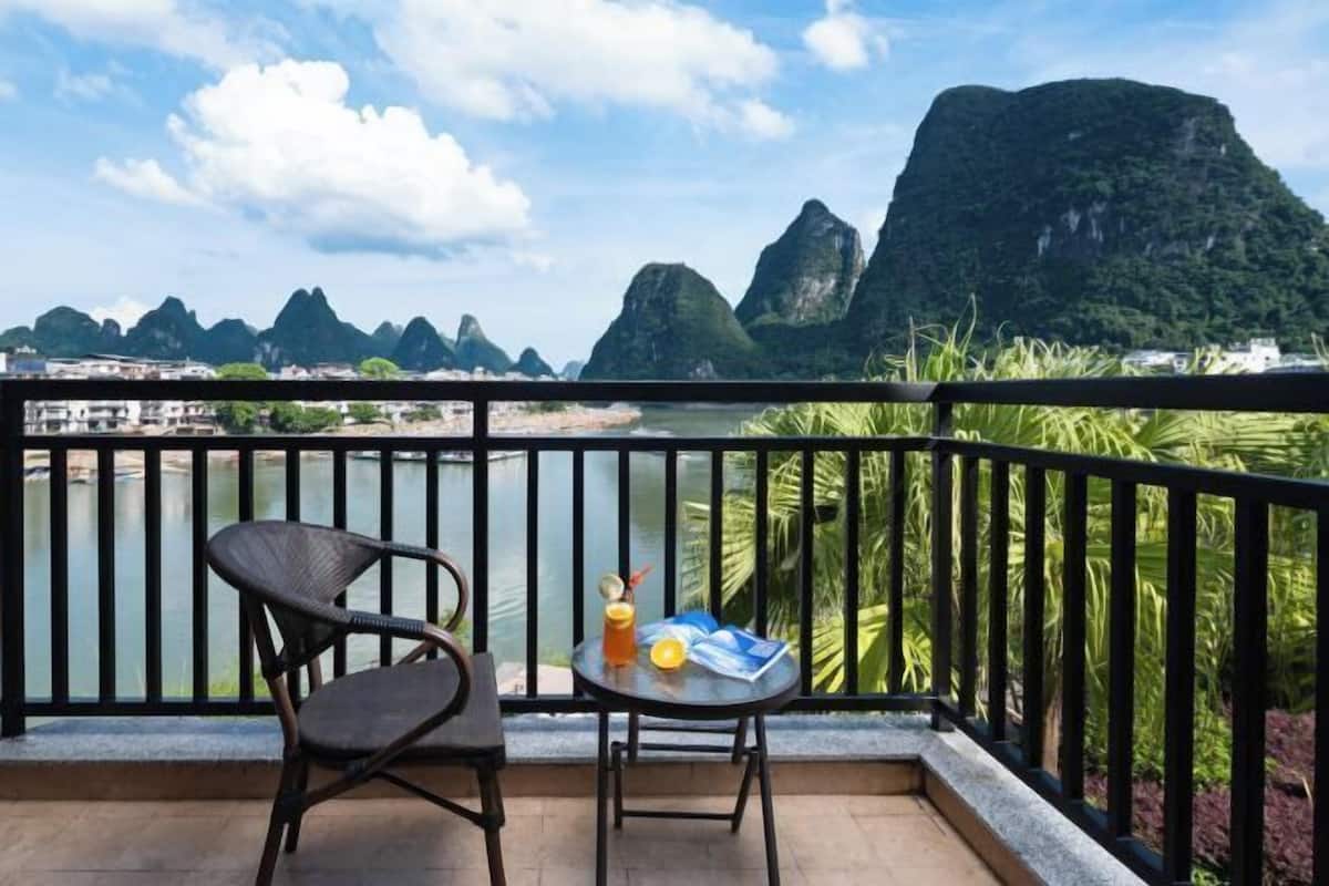 A balcony with a view of limestone karsts and a river.