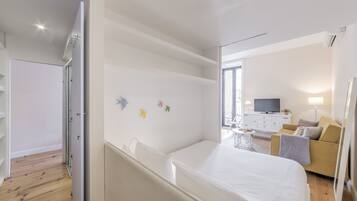 Relax in this stylish room with a large bed, flat-screen TV, and comfortable sofa.