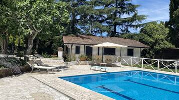 Seasonal outdoor pool, open 10:30 AM to 7:00 PM, pool umbrellas