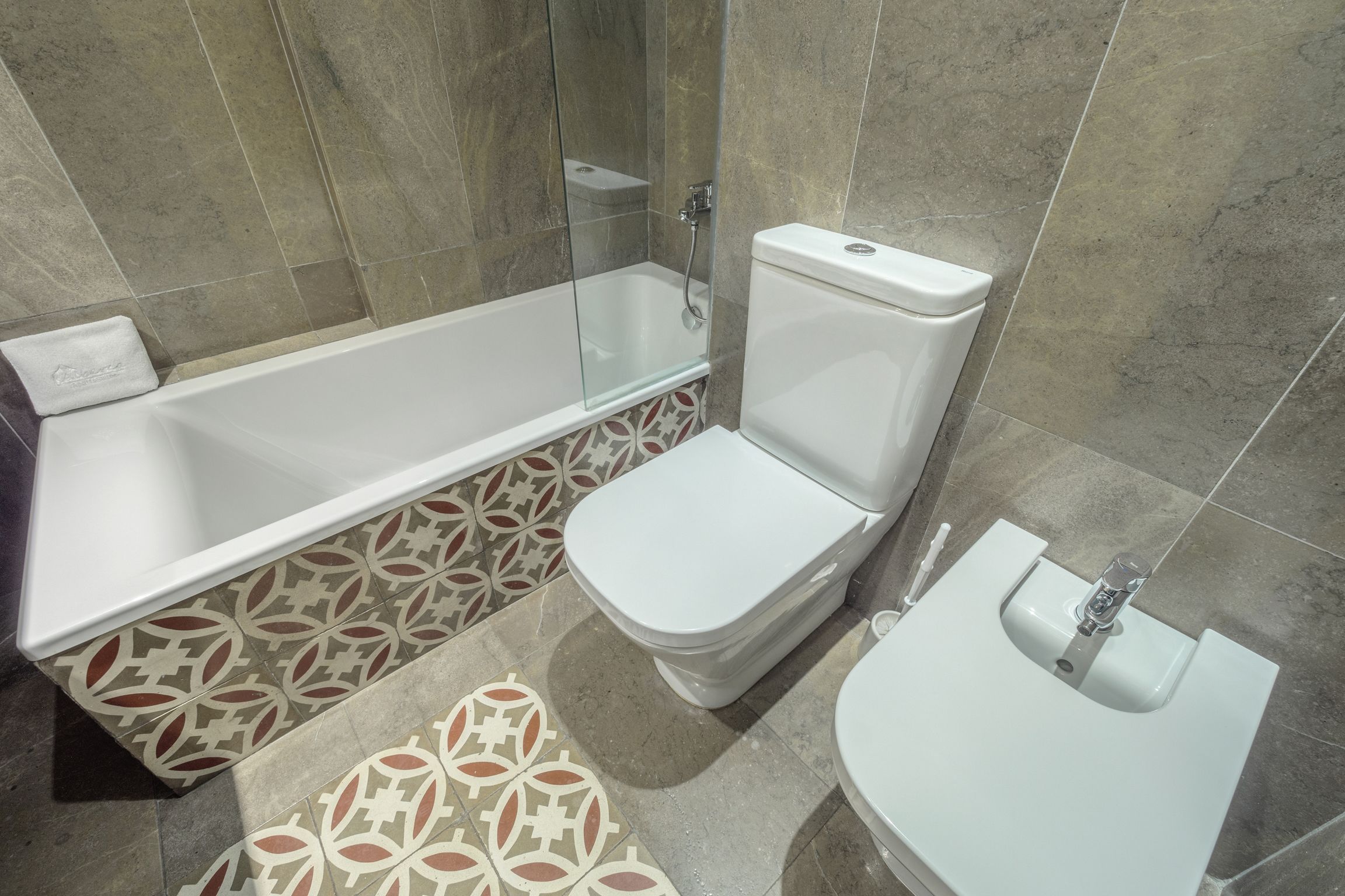 Een badkamer met een bad, toilet en wastafel.