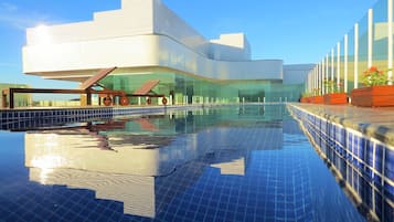 Una piscina al aire libre, tumbonas
